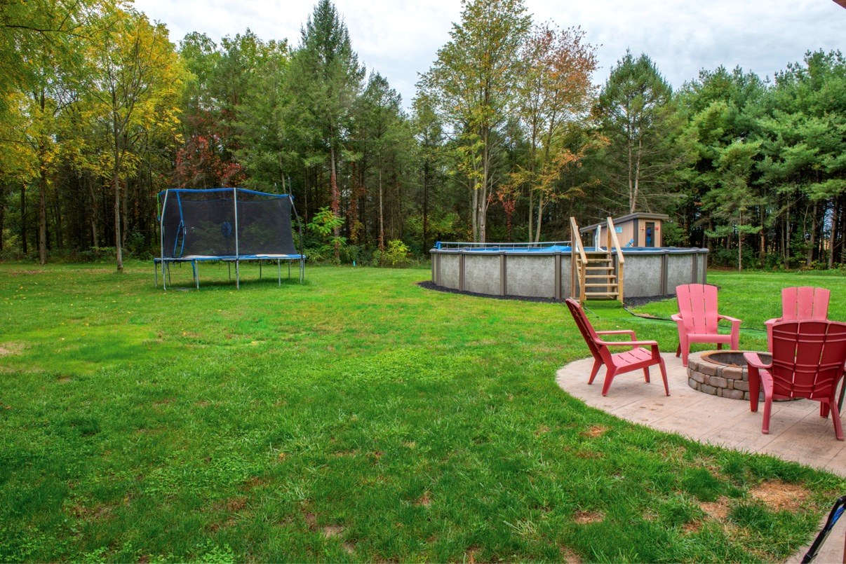 Backyard with saltwater pool, fire pit patio and lawn