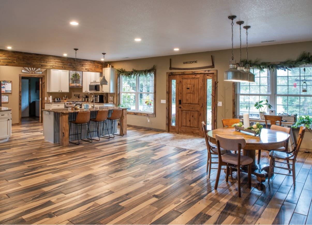 Open kitchen and dining with island, pendant lights and wood floors