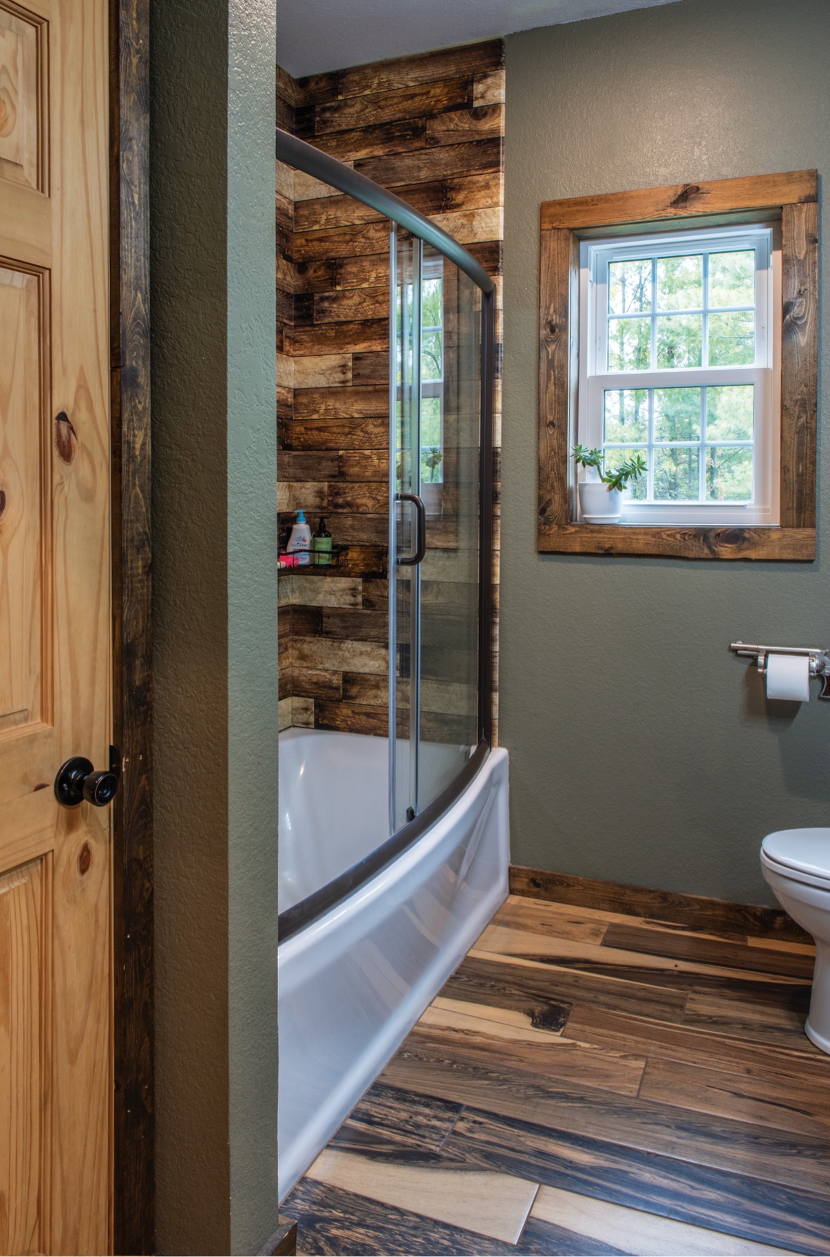 Second bathroom tub and shower with wood walls