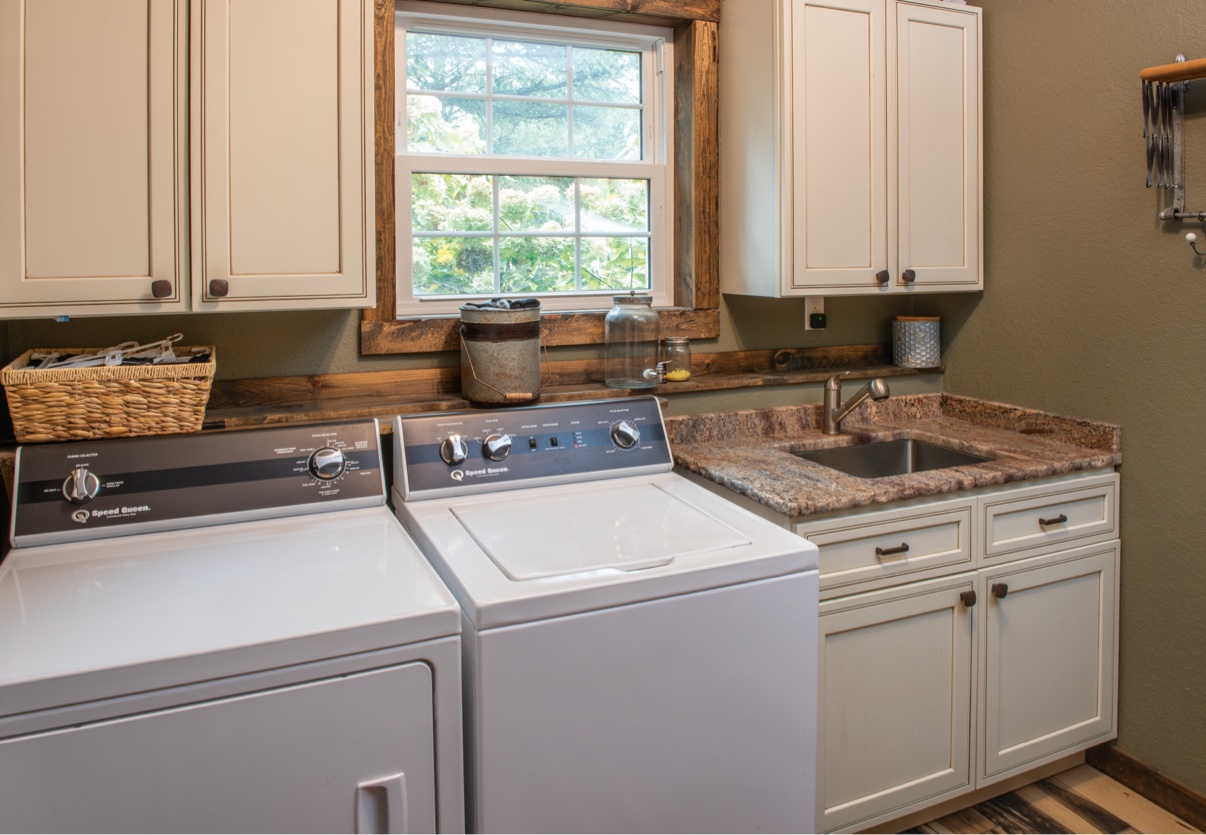 Laundry room with washer dryer and sink