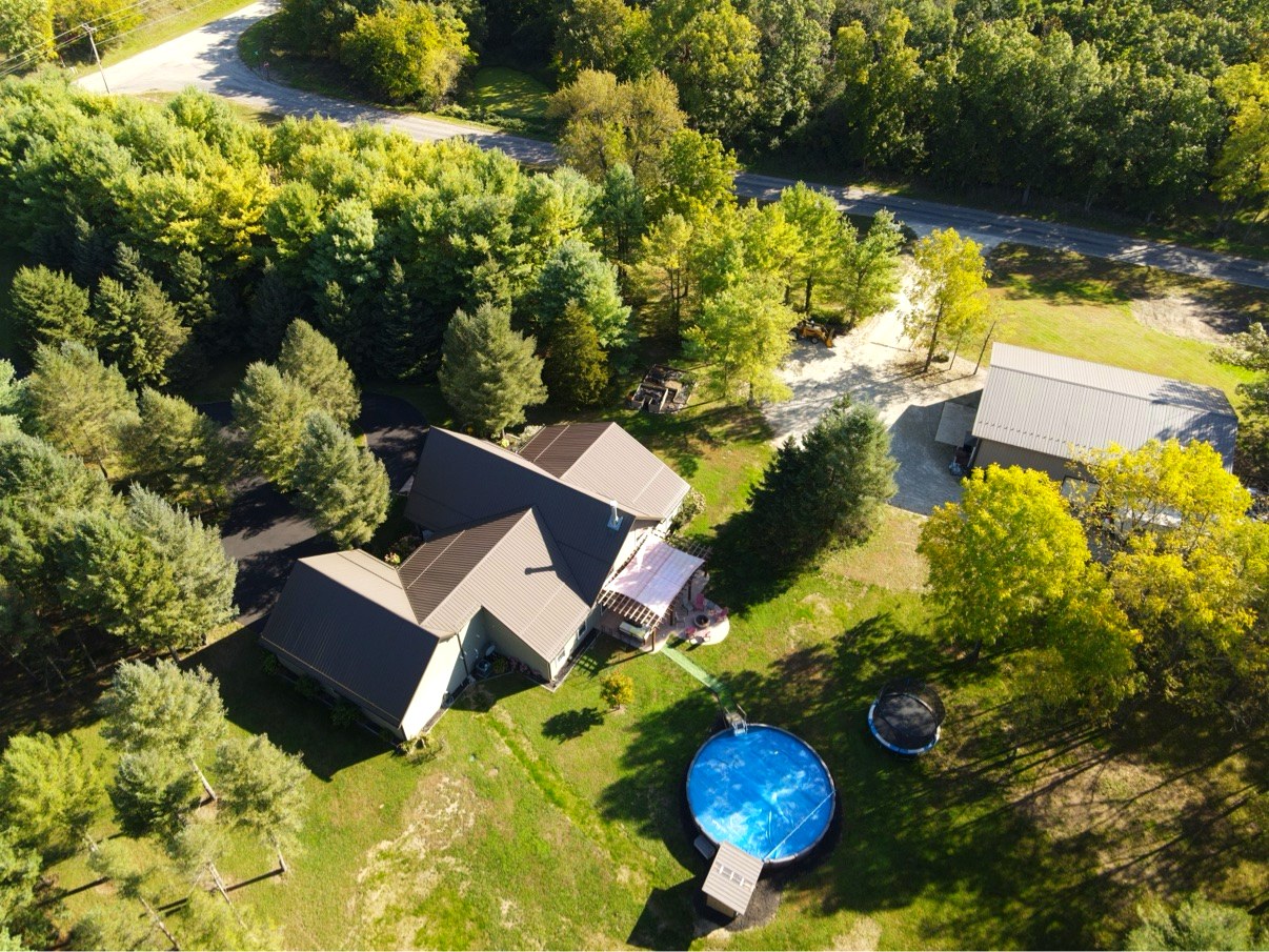 Aerial rear view of house pool and barn